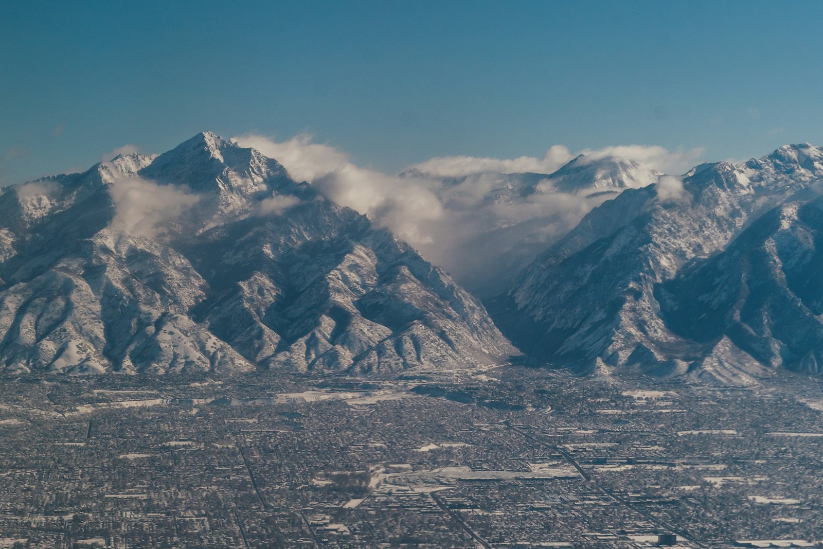 Aerial view of the Salt Lake Valley suburbs below the snow-covered Wasatch Range